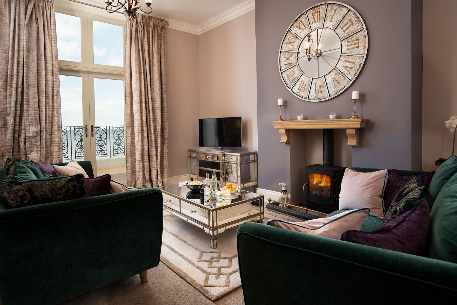 A living room with a log burner in one of the 5leys properties